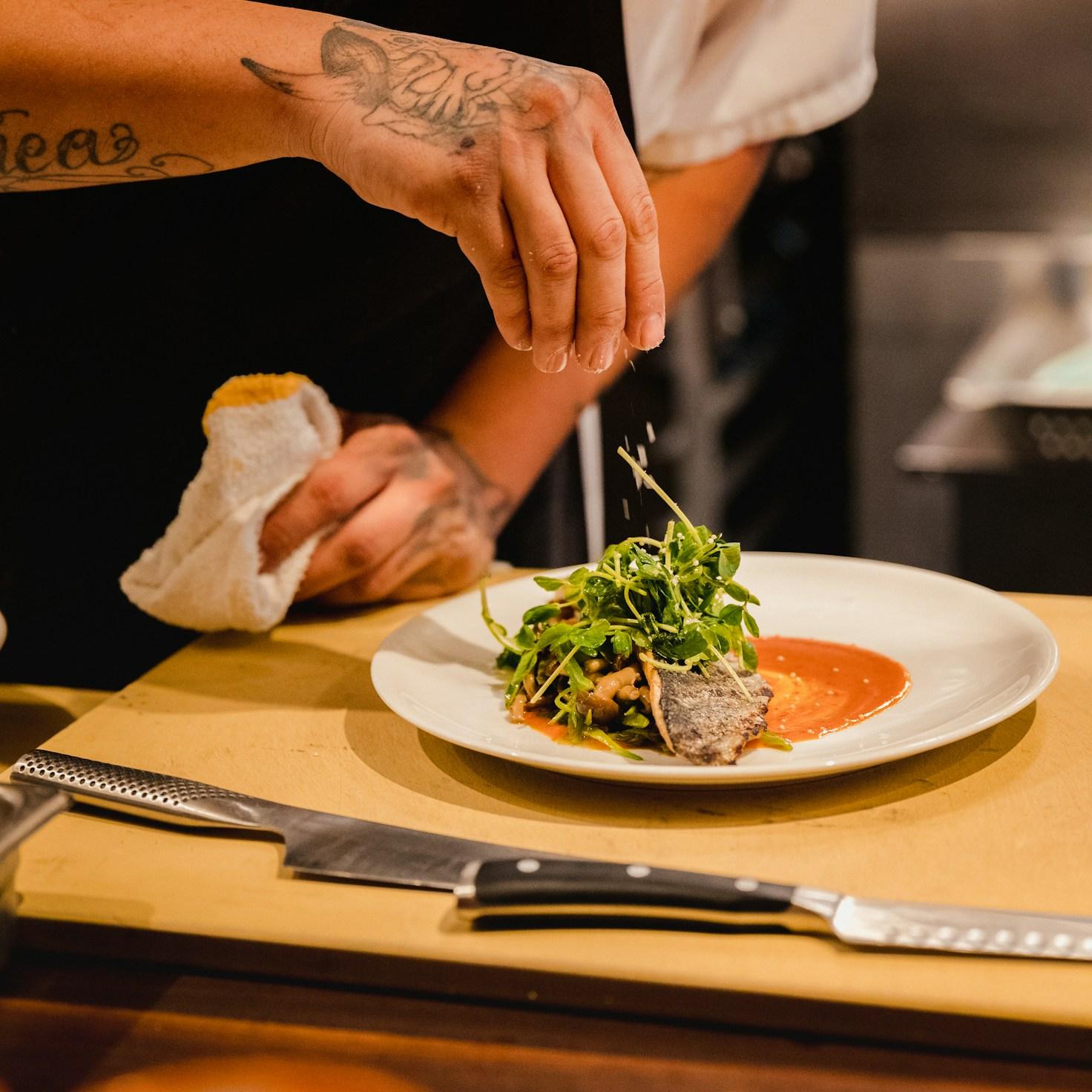 Community members collaborating in a contemporary kitchen, sharing recipes and cooking techniques